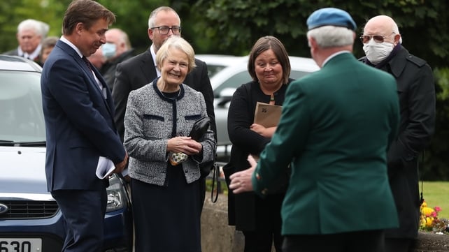 Pat Hume welcomes mourners to her husband's funeral