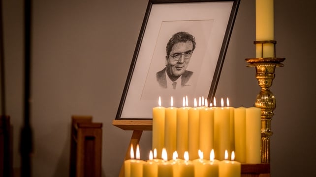 Portrait and candles in tribute to John Hume inside the cathedral