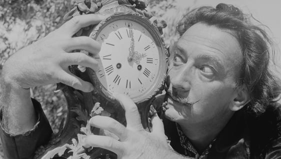 Spanish surrealist artist Salvador Dali (1904 - 1989) clutches an ornate clock at his home in Cadaq…