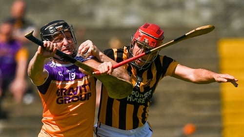 Jim Berry of Faythe Harriers in action against Ciaran Shaughnessy of Shelmaliers