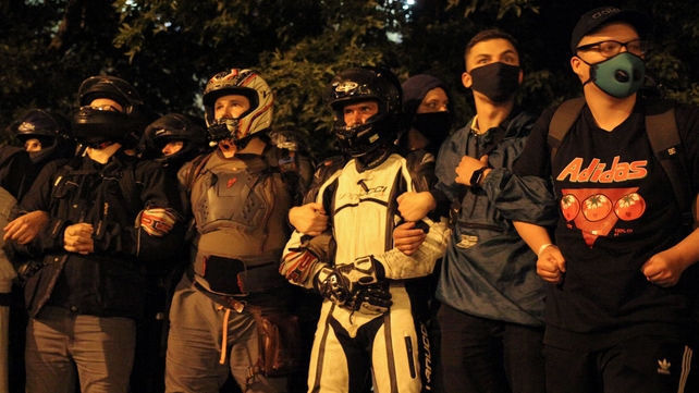 Opposition supporters stand firm after polls closed in the election