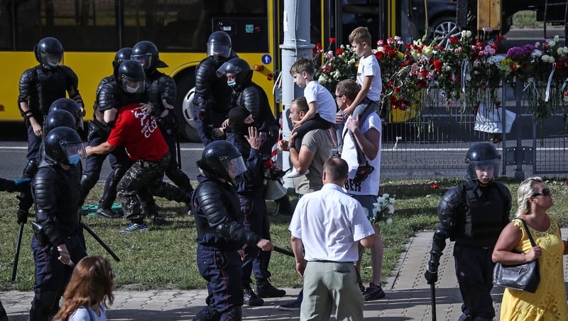 Riot police detain a man participating in a memorial event for the person killed during a protest in Belarus