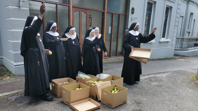 Some of the sisters at the Priory of St Benedict waving off OPW staff as they dropped off some boxes of apples