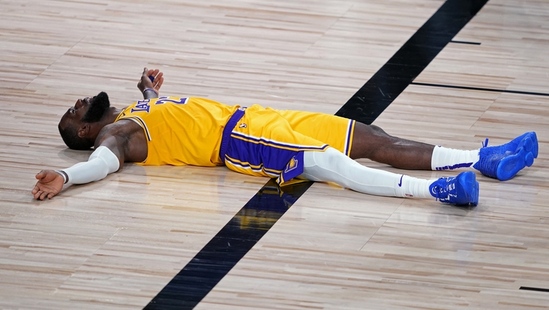 LeBron James Lakers lies on the court floor after committing a foul against the Portland Trail Blazers