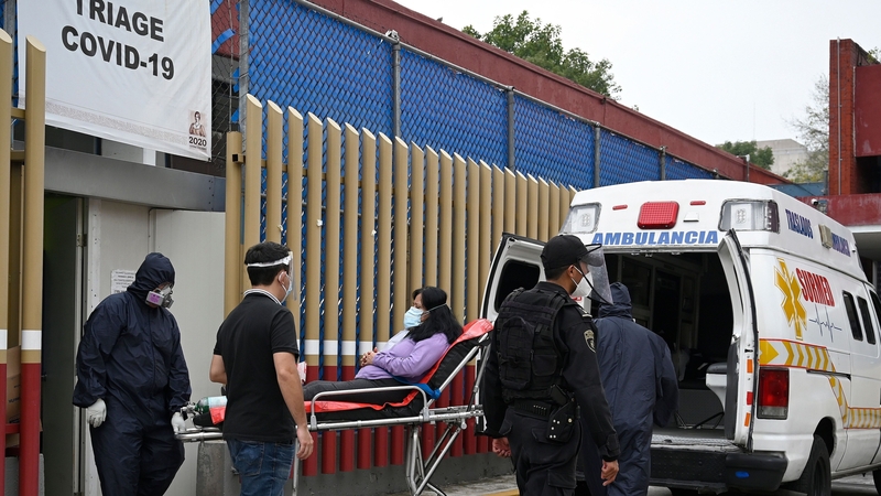 Paramedics move a patient suspected of having the coronavirus at the Covid-19 triage area of the General Hospital in Mexico City