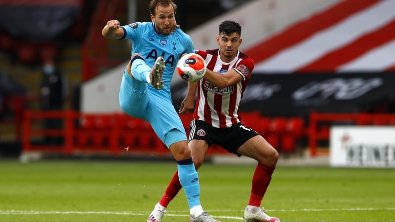John Egan (R) in action against Spurs' Harry Kane last season