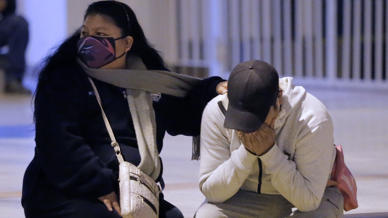 People grieve outside the nightclub in Lima where at least 13 people suffocated in a crush