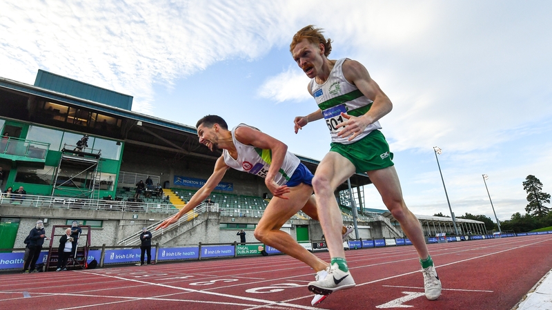 Paul Robinson of St Coca's AC, Kildare, left, crosses the finish line to win