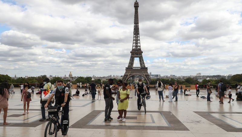 Bicycle police wearing face masks patrol on the Trocadero esplanade near the Eiffel Tower in Paris