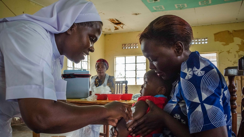 A child reacts as he receives an injection during a nationwide vaccination campaign in Uganda