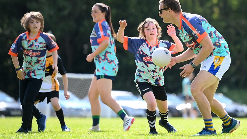 Dublin footballers Ciarán Kilkenny (R) and Sinéad Goldrick (background) at the Cúl Camp in St Brendan's GAA Club, Dublin last month
