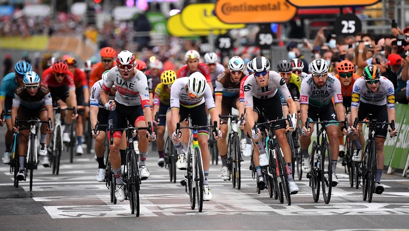Alexander Kristoff of Norway celebrates (L) as he crosses the line as Sam Bennett on the extreme right finishes fourth