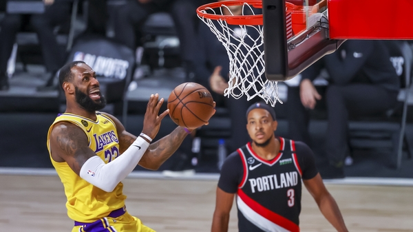 Los Angeles Lakers forward LeBron James (L) in action against Portland Trail Blazers guard CJ McCollum