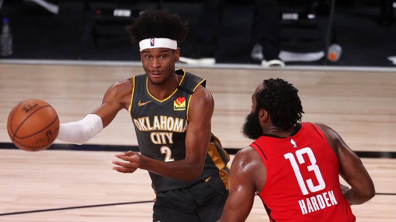 Shai Gilgeous-Alexander #2 of the Oklahoma City Thunder drives the ball against James Harden #13 of the Houston Rockets