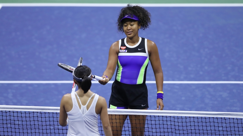 Naomi Osaka taps rackets after winning during her Women's Singles first round match against Misaki Doi