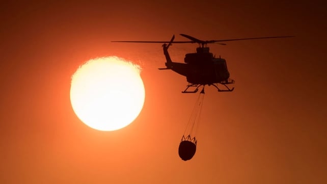 A helicopter prepares to drop water over the Spanish blaze