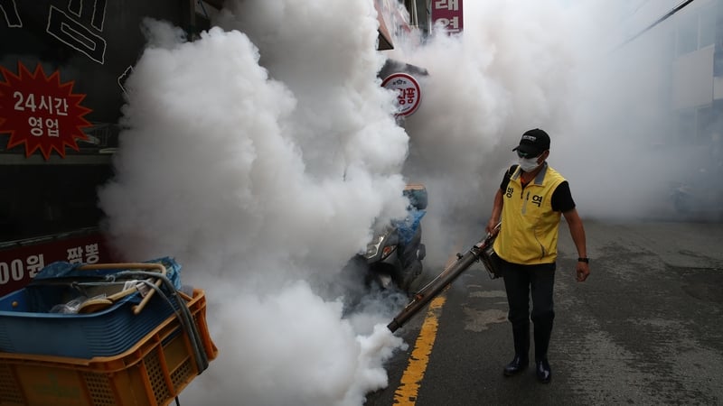 A worker disinfects an alley to prevent the spread of coronavirus in Seoul
