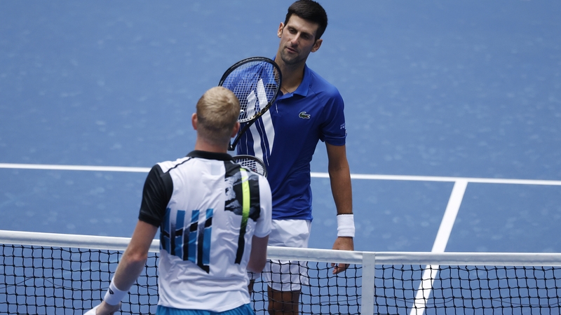 Novak Djokovic meets Kyle Edmund at the net after their clash at Arthur Ashe Stadium