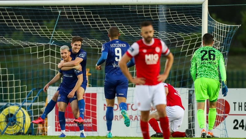 Allistar Coote's team-mates celebrate with him after he opened the scoring at the RSC