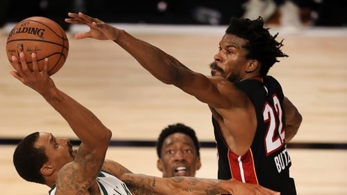 George Hill #3 of the Milwaukee Bucks drives to the basket against Jimmy Butler #22 of the Miami Heat