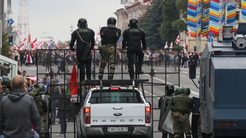 Riot police officers block Independence Avenue in Minsk during the March of Unity today