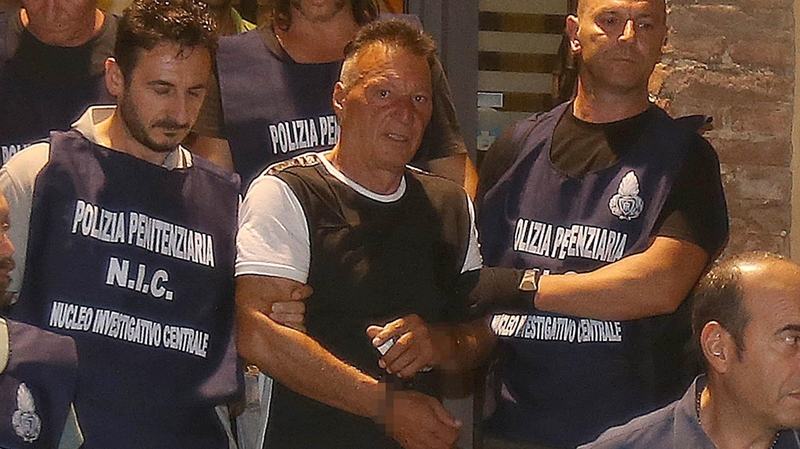 Giuseppe Mastini (centre) took advantage of a temporary release from a high-security jail in Sardinia to flee, failing to return to his cell on Saturday (file pic)