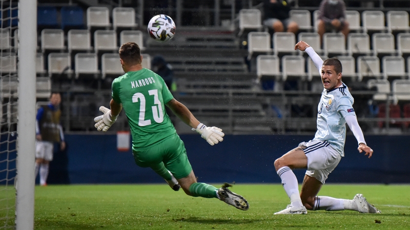 Lyndon Dykes lifts the ball over the Czech goalkeeper