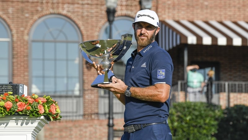 Dustin Johnson poses with the FedEx Cup