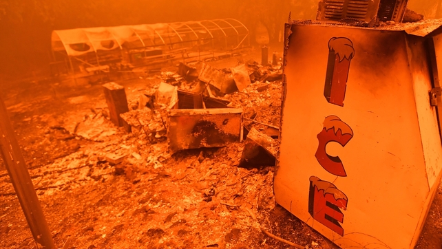 A singed ice machine sits over a burned store during the Bear fire, part of the North Lightning Complex fires, in unincorporated Butte County, California