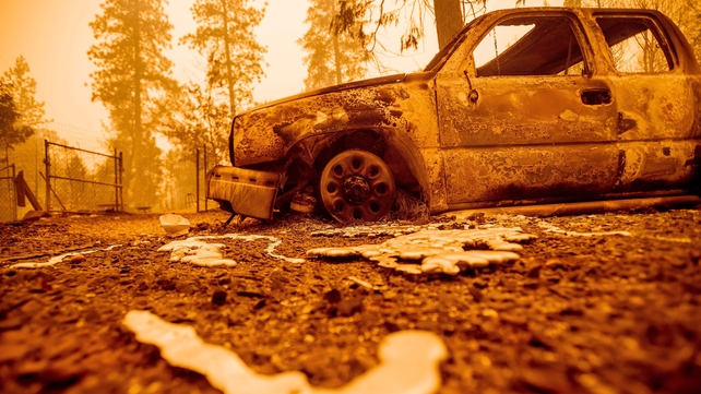 Melted metal sits in place after flowing from a smoldering vehicle during the Bear fire, part of the North Lightning Complex fires, in Butte County