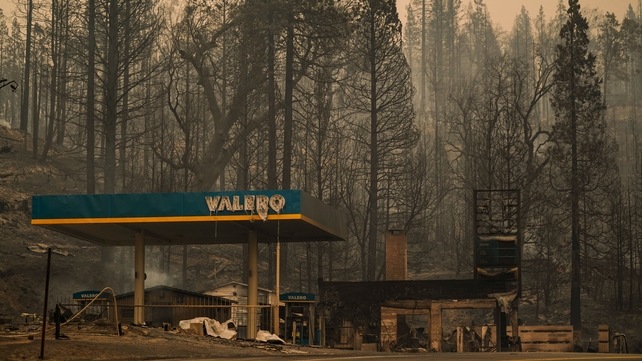 A burned Valero gas station smolders during the Creek fire in an area of Fresno County, California