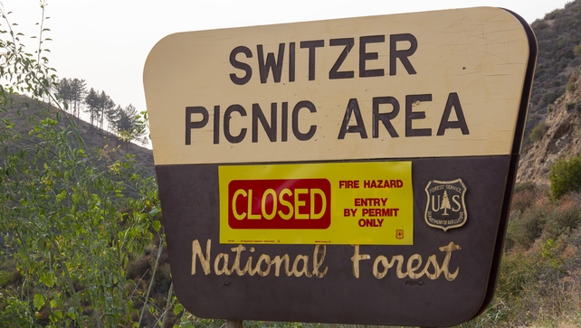 Signage warns residents that the Angeles National Forest is closed as the Bobcat Fire burns nearby on September 9, 2020 near Monrovia