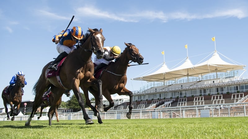 Fancy Blue ridden by Ryan Moore (left) wins The Qatar Nassau Stakes