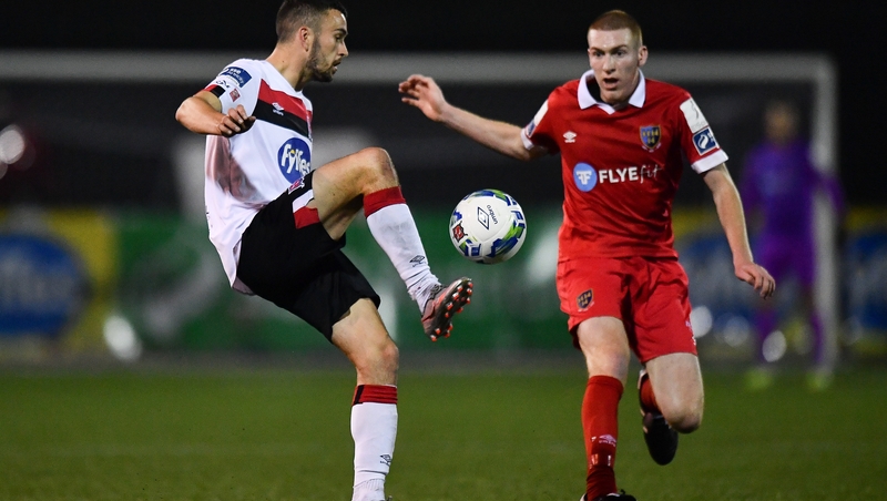 Michael Duffy of Dundalk in action against Sean Quinn of Shelbourne