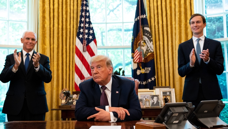 Donald Trump, flanked by Mike Pence and Jared Kushner, announced the deal