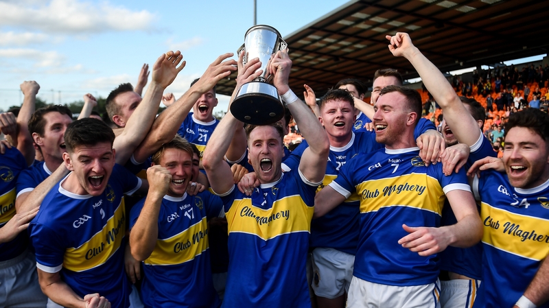David Lavery, holding the trophy, celebrates with his teammates