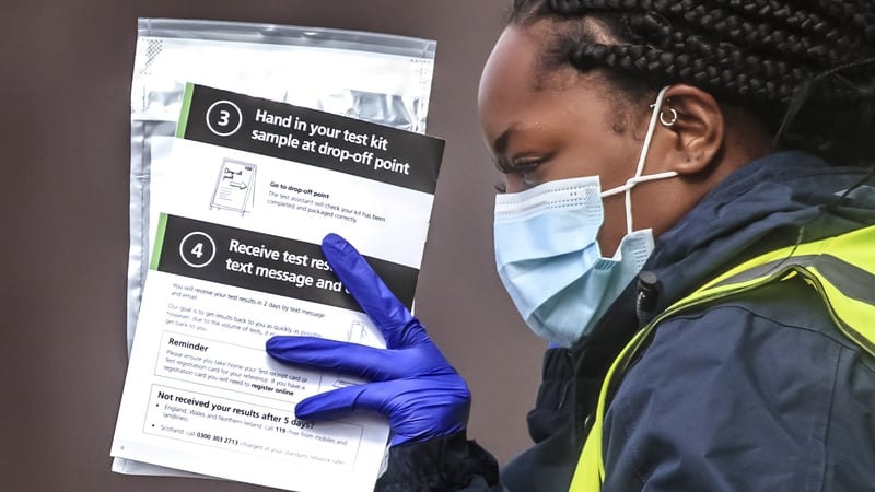Staff hand out self test kits at a coronavirus testing centre at the Last Drop Village Hotel in Bolton