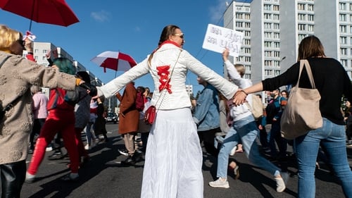 Belarusian women have taken to the streets with flowers and flags to demand change
