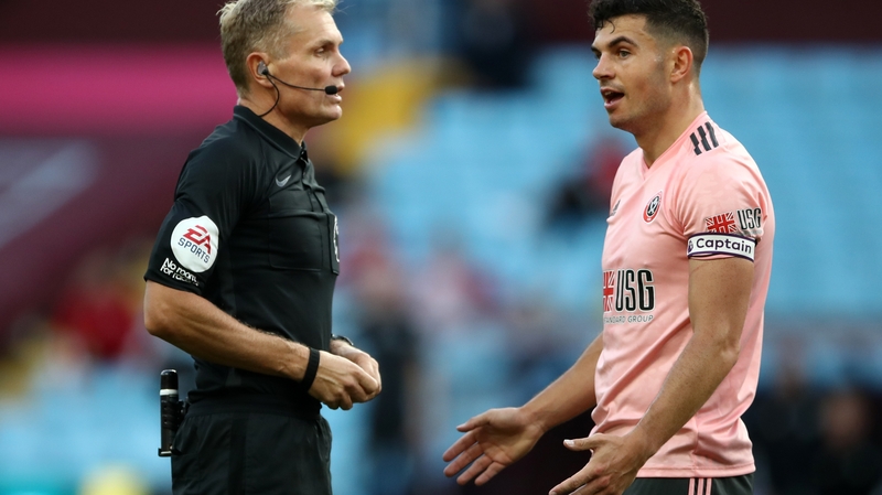 John Egan reacts after getting sent off by referee Graham Scott