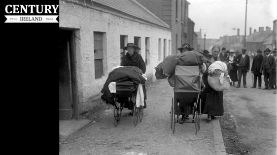 Three local women pushing prams, laden with clothes and blankets, leave Balbriggan, County Dublin, …