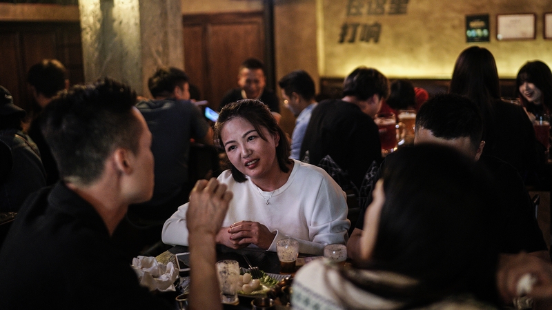 People drink inside a bar in Wuhan, China. There have been no recorded cases of community transmission in Wuhan since May