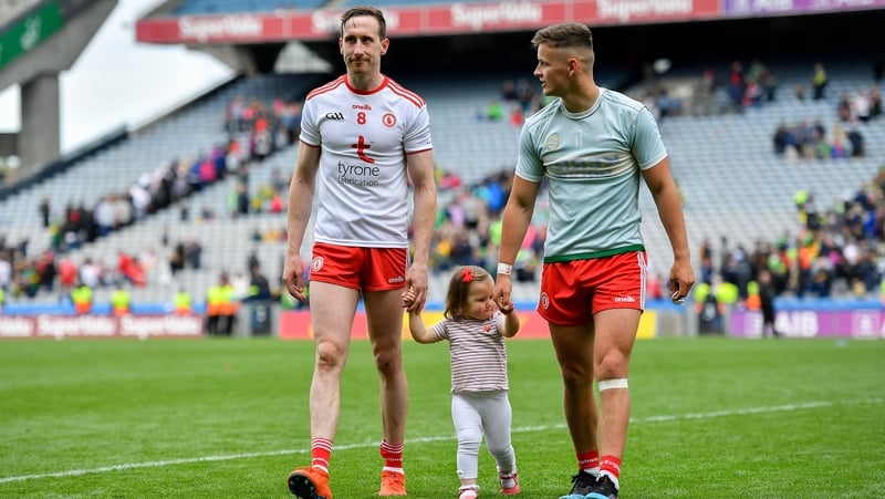Colm Cavanagh and his daughter Chloe leave the Croke Park pitch with team-mate Michael McKernan after the 2019 All-Ireland semi-final against Kerry