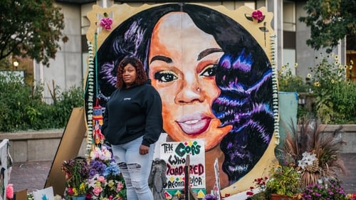 Tamika Palmer, mother of Breonna Taylor, poses for a portrait in front of a mural of her daughter in Louisville, Kentucky