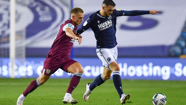 Josh Benson of Burnley challenges Millwall's Troy Parrott