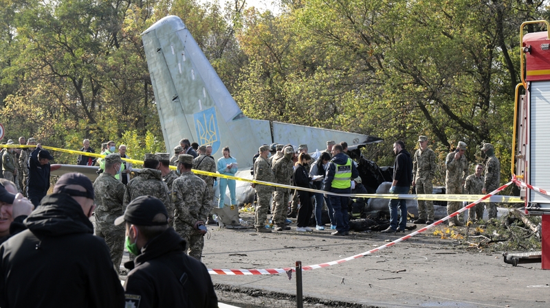 Rescuers inspect the crash site of the Antonov-26 plane in Kharkiv, Ukraine today
