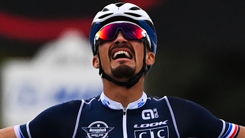 France's Julian Alaphilippe celebrates as he crosses the finish line to win