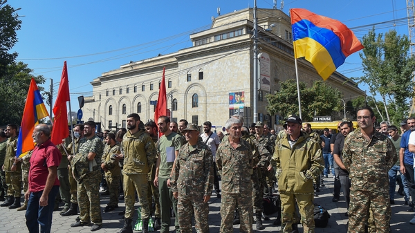 Servicemen and members of the Armenian Revolutionary Federation (ARF) gather among volunteers who are to set off for Nagorno-Karabakh