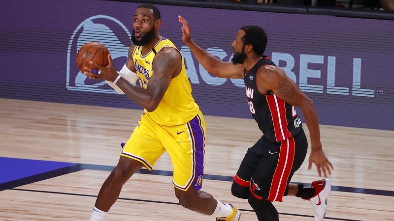 LeBron James, left, drives past Andre Iguodala of the Miami Heat