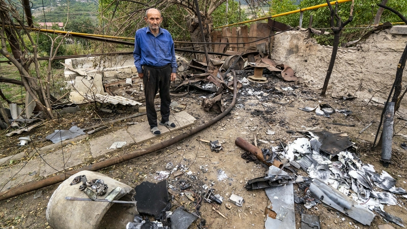 A man is surrounded by debris from an Azeri drone shelling that killed his wife in Hadrut, Nagorno-Karabakh