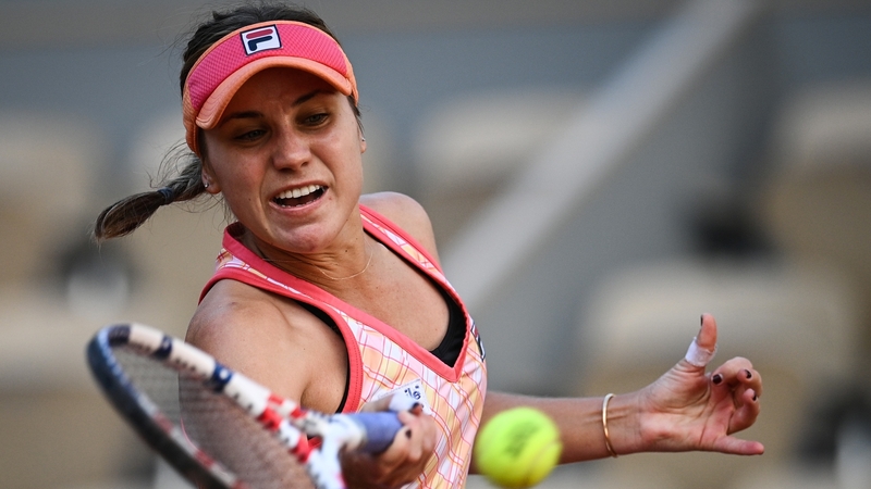 Sofia Kenin returns the ball to Irina Bara on the way to victory
